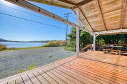Rustic waterfront woodland lodge with impressive lake views from patio