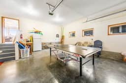 Two story oceanfront retreat with a washer dryer firepit and Ping Pong table