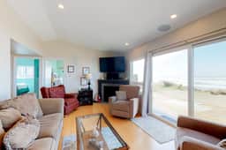 Beachfront home with ocean facing deck and ocean views throughout modern kitchen