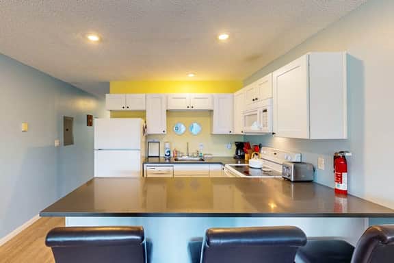 Creekside condo with beach access balcony full kitchen and ocean views