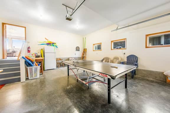 Two story oceanfront retreat with a washer dryer firepit and Ping Pong table