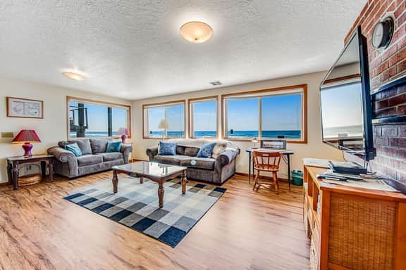 Two story oceanfront retreat with a washer dryer firepit and Ping Pong table